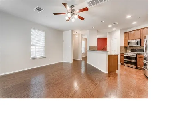 a view interior of a house and kitchen with stainless steel appliances