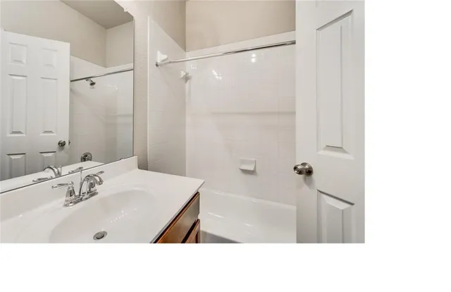 a bathroom with a sink a shower and a mirror