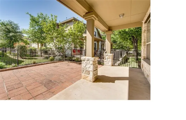 a view of a porch with a floor to ceiling window next to a yard