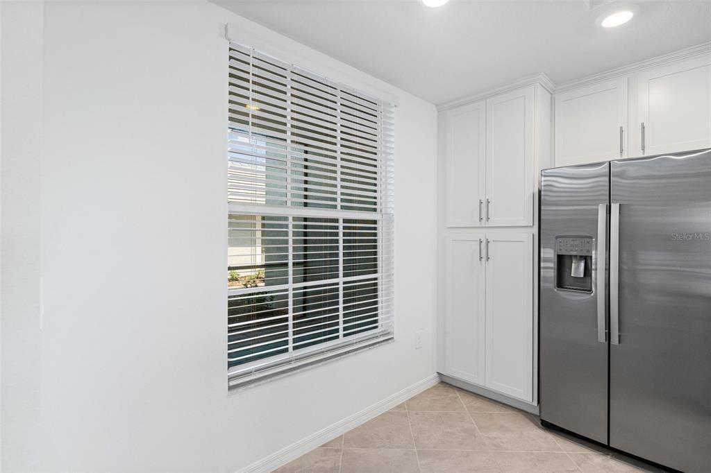 19007 Scallop Loop, Unit 108 Lakewood Ranch, FL 34211 - Photo 11 of 59 a view of kitchen with refrigerator cabinets and a window