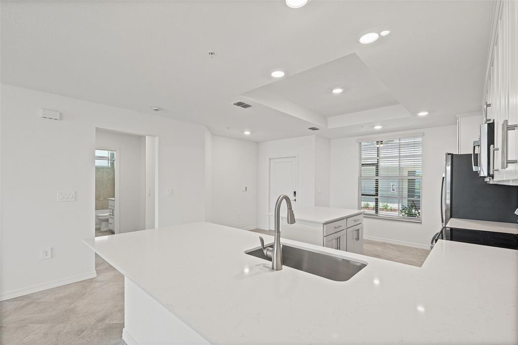 19007 Scallop Loop, Unit 108 Lakewood Ranch, FL 34211 - Photo 15 of 59 a large white kitchen with a large window