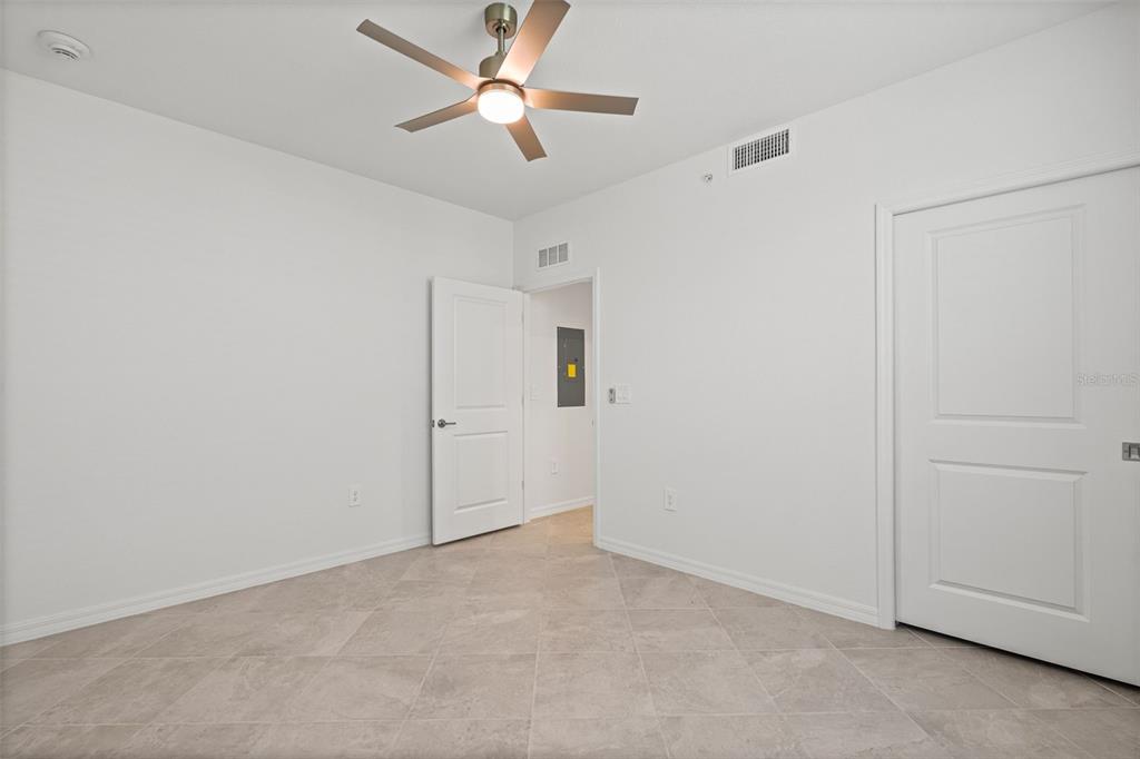 19007 Scallop Loop, Unit 108 Lakewood Ranch, FL 34211 - Photo 18 of 59 an empty room with closet and a ceiling fan
