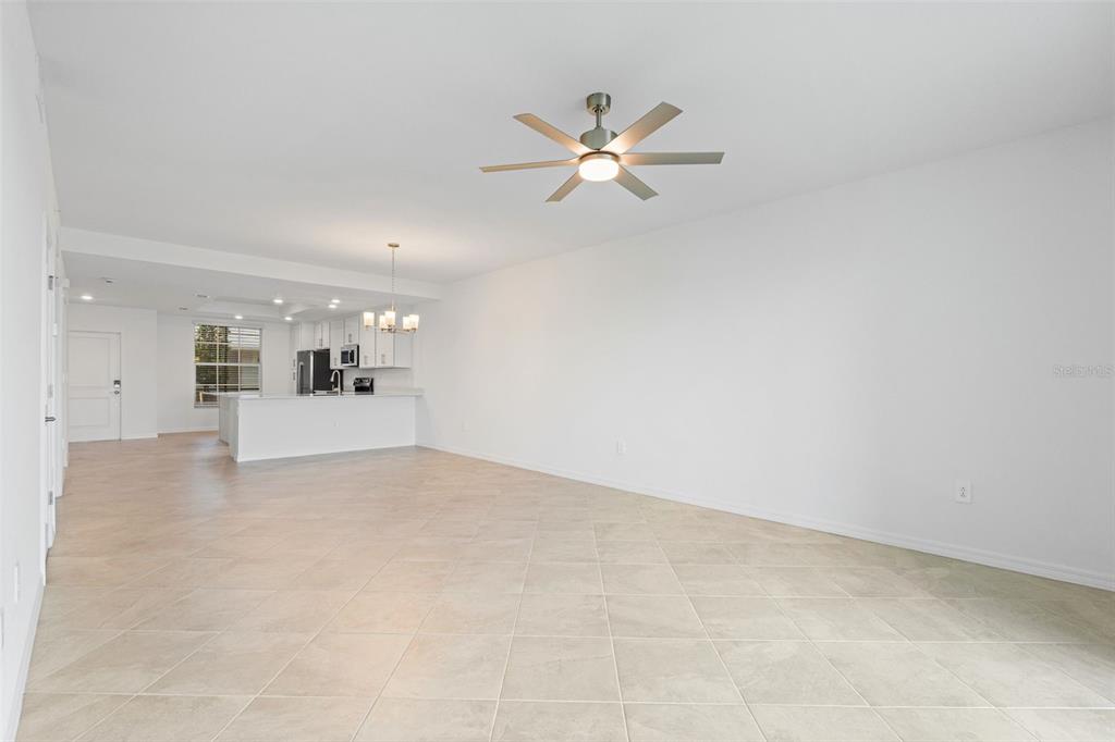 19007 Scallop Loop, Unit 108 Lakewood Ranch, FL 34211 - Photo 35 of 59 a view of a big room with chandelier fan and windows