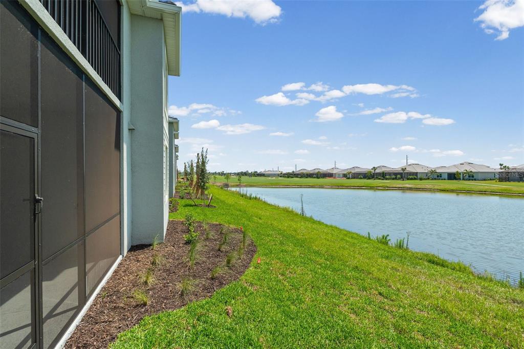 19007 Scallop Loop, Unit 108 Lakewood Ranch, FL 34211 - Photo 45 of 59 a view of a lake with a big yard