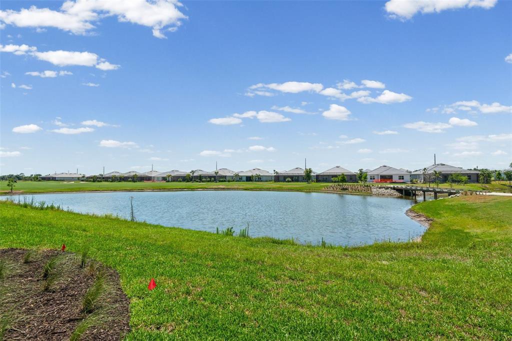 19007 Scallop Loop, Unit 108 Lakewood Ranch, FL 34211 - Photo 50 of 59 a view of a lake with houses in the back