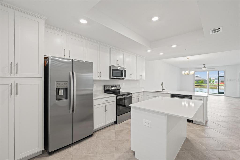 19007 Scallop Loop, Unit 108 Lakewood Ranch, FL 34211 - Photo 10 of 59 a kitchen with stainless steel appliances a refrigerator sink and microwave