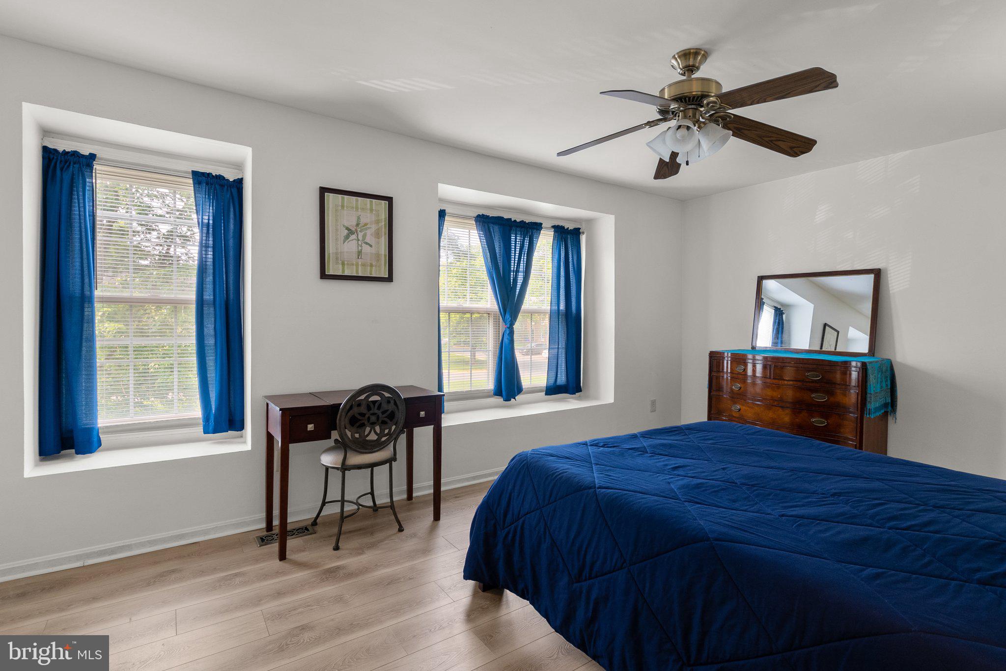 20249 Maple Leaf Court Montgomery Village, MD 20886 - Photo 14 of 30 a bedroom with a bed and wooden floor