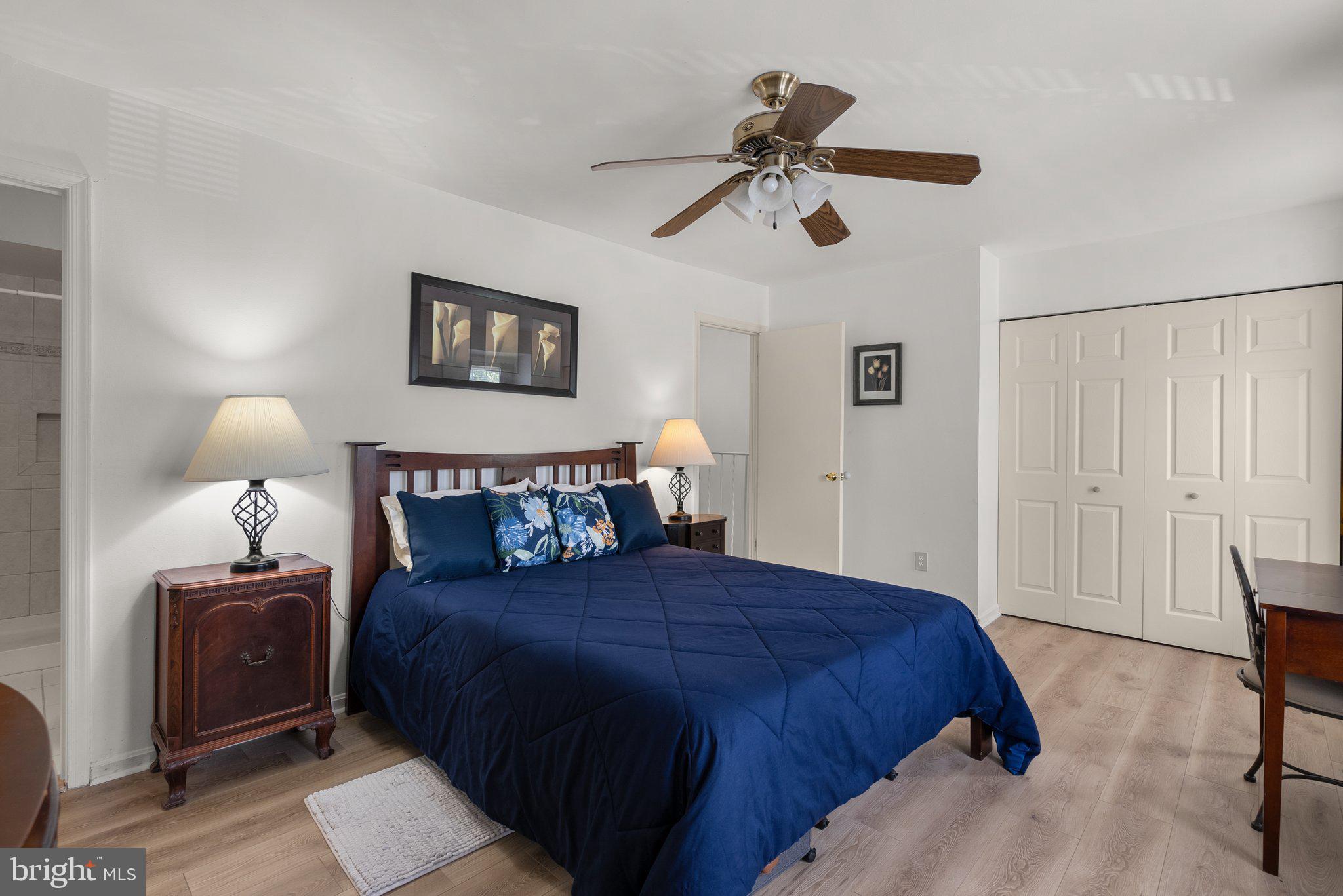 20249 Maple Leaf Court Montgomery Village, MD 20886 - Photo 15 of 30 a bedroom with a bed and a lamp