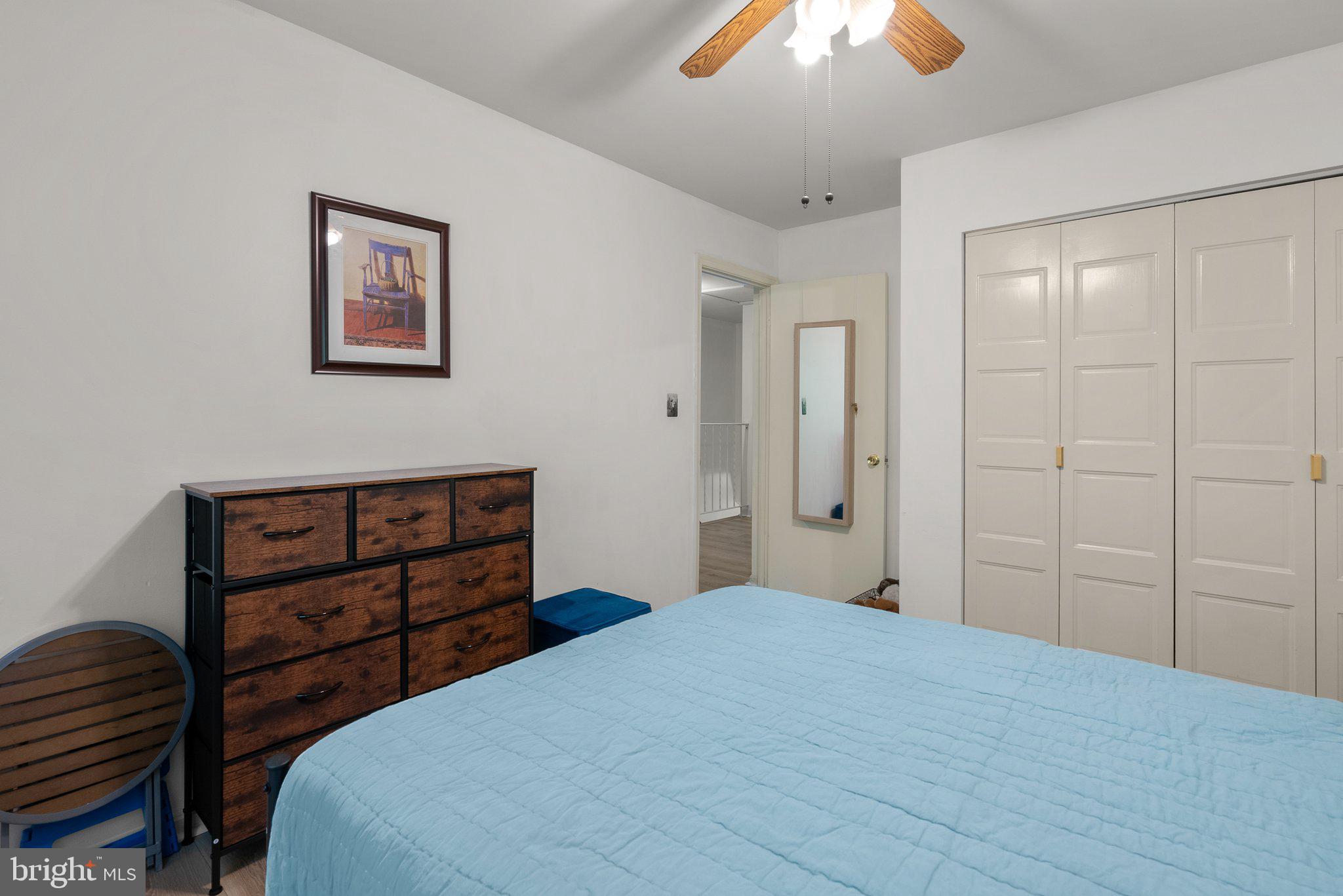 20249 Maple Leaf Court Montgomery Village, MD 20886 - Photo 20 of 30 a bedroom with a bed and a chandelier