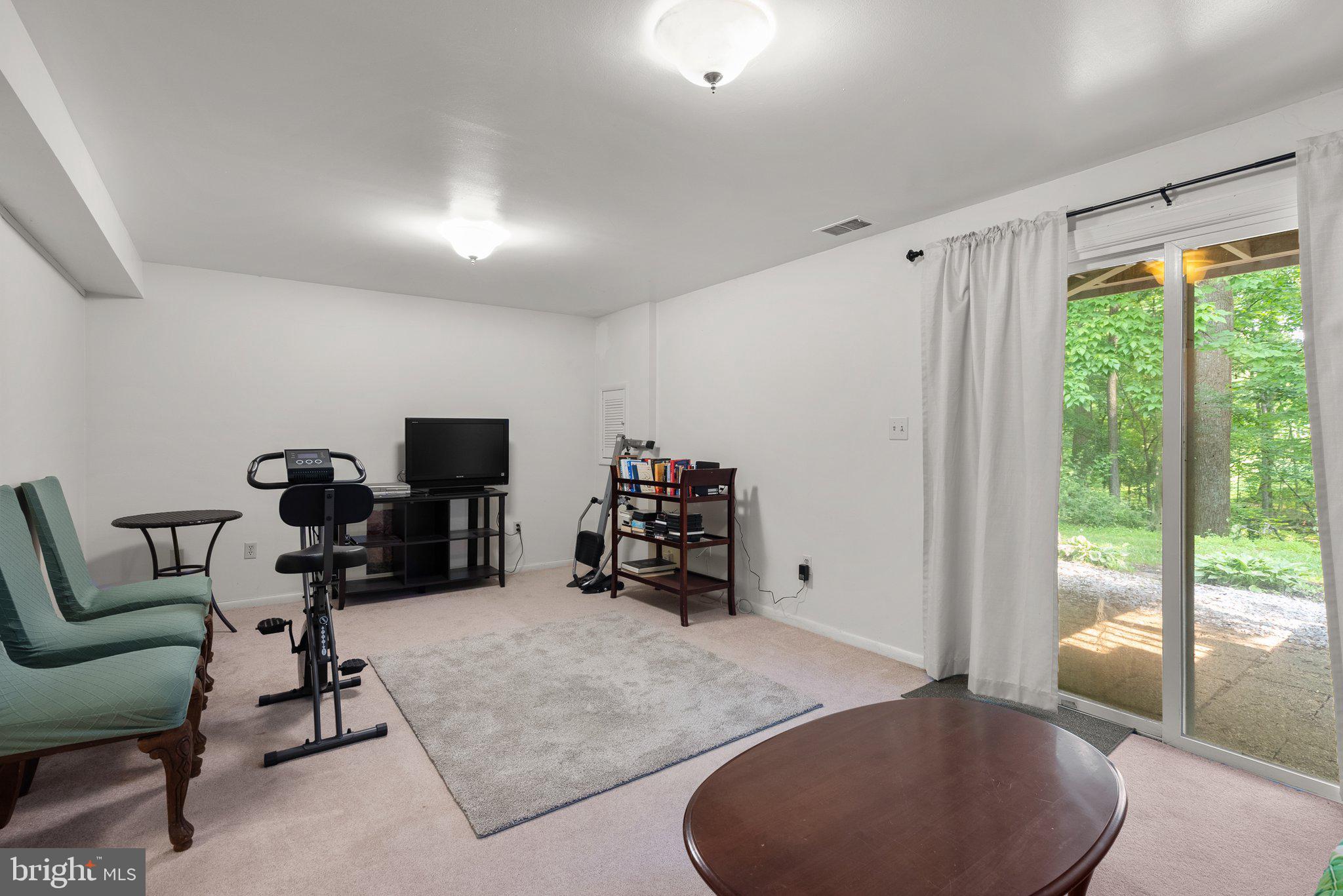 20249 Maple Leaf Court Montgomery Village, MD 20886 - Photo 22 of 30 a room with furniture and a flat screen tv