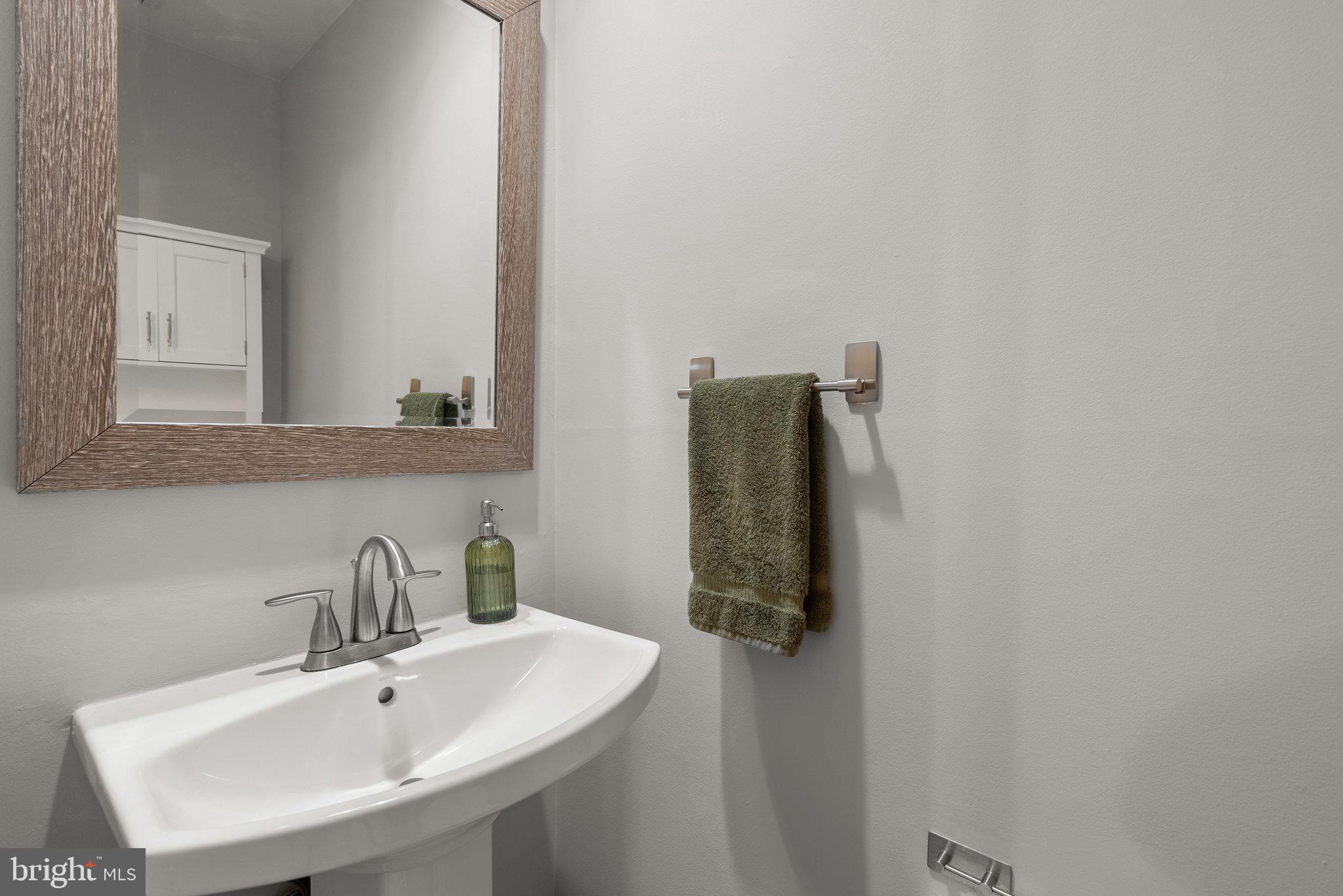 20249 Maple Leaf Court Montgomery Village, MD 20886 - Photo 25 of 30 a bathroom with a sink and mirror
