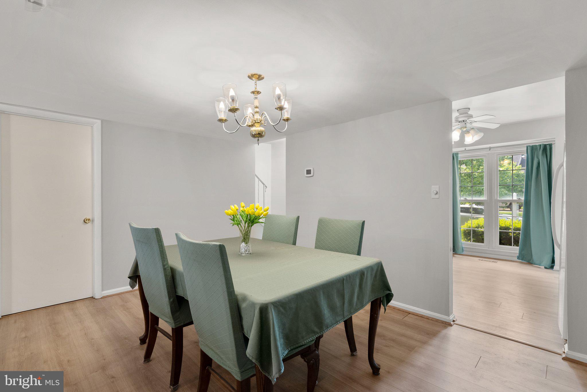 20249 Maple Leaf Court Montgomery Village, MD 20886 - Photo 8 of 30 a view of a dining room with a table and chairs