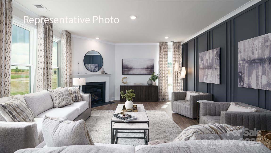 3044 Canvasback Way Indian Trail, NC 28079 - Photo 15 of 43 a living room with furniture fireplace and a large window
