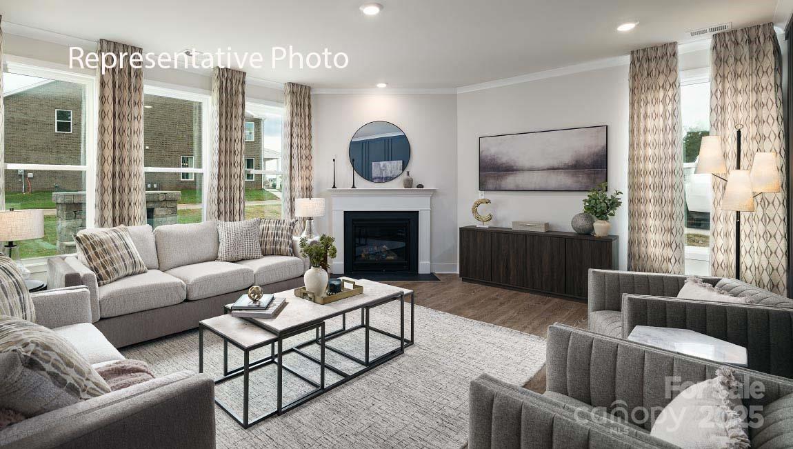 3044 Canvasback Way Indian Trail, NC 28079 - Photo 16 of 43 a living room with furniture fireplace and flat screen tv