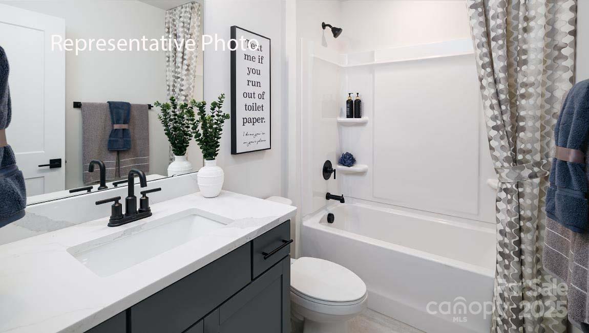 3044 Canvasback Way Indian Trail, NC 28079 - Photo 18 of 43 a bathroom with a sink a toilet a mirror a vanity and shower