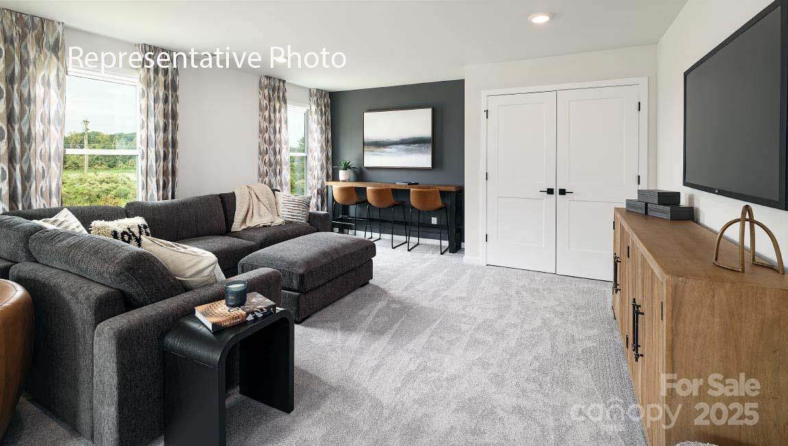 3044 Canvasback Way Indian Trail, NC 28079 - Photo 20 of 43 a living room with furniture and a flat screen tv