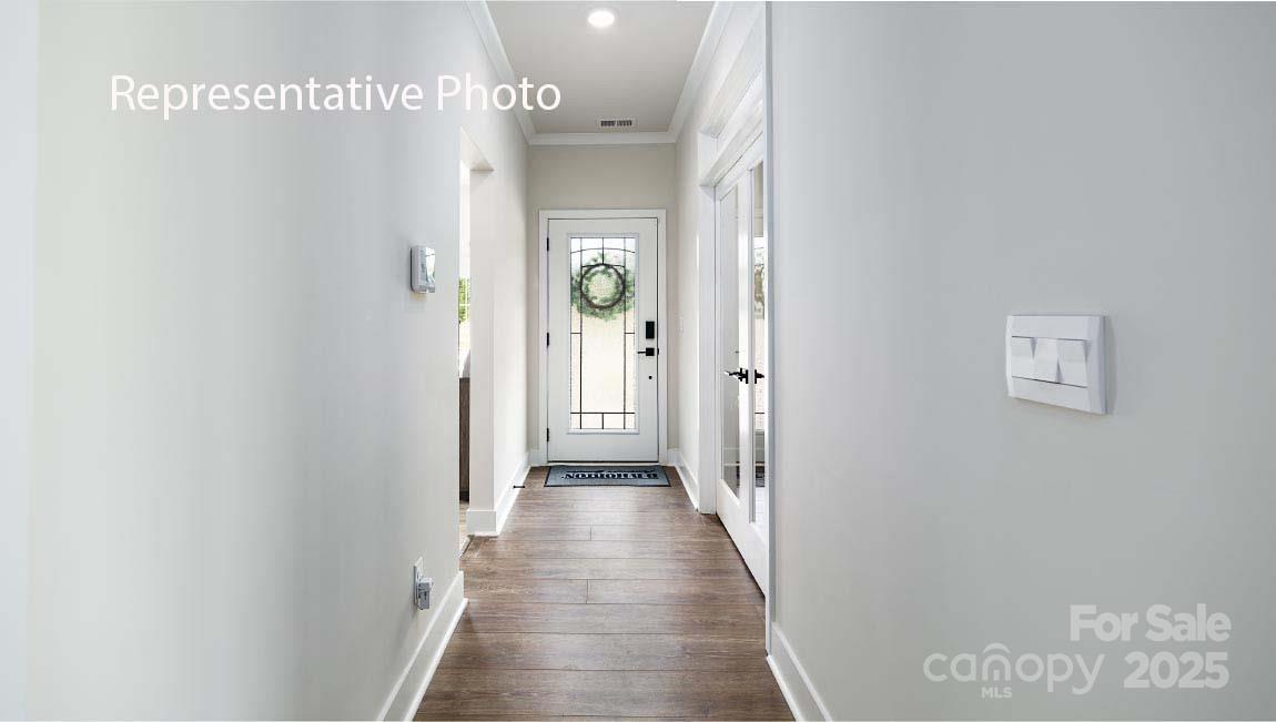3044 Canvasback Way Indian Trail, NC 28079 - Photo 2 of 43 a view of a hallway with wooden floor
