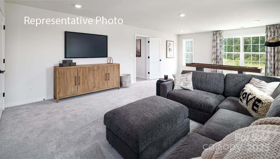 3044 Canvasback Way Indian Trail, NC 28079 - Photo 21 of 43 a living room with furniture and a flat screen tv