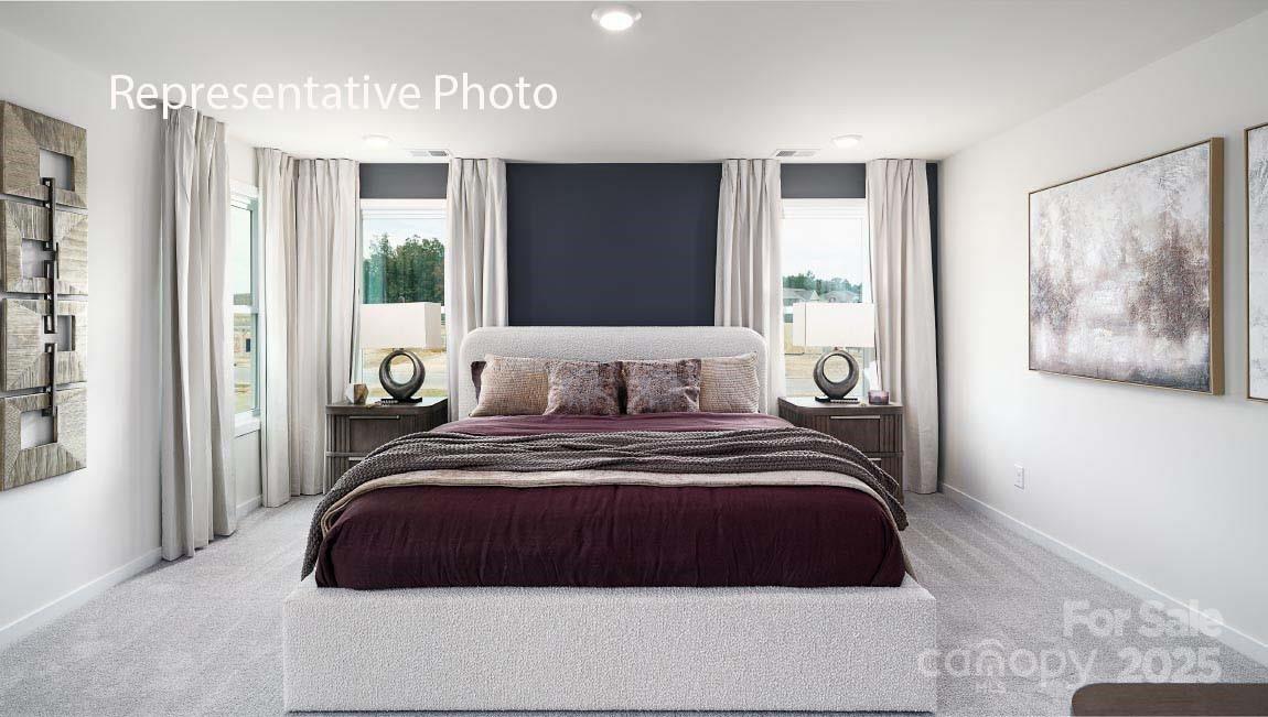 3044 Canvasback Way Indian Trail, NC 28079 - Photo 22 of 43 a bedroom with a large bed and a large window