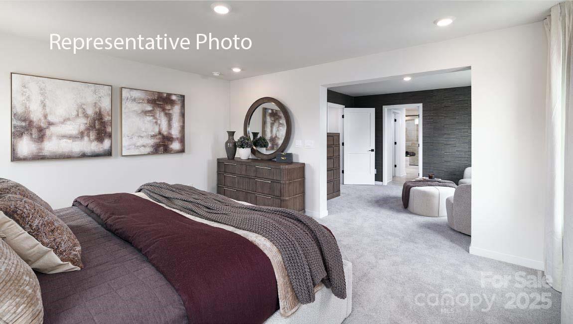 3044 Canvasback Way Indian Trail, NC 28079 - Photo 24 of 43 a bedroom with a bed and a large mirror