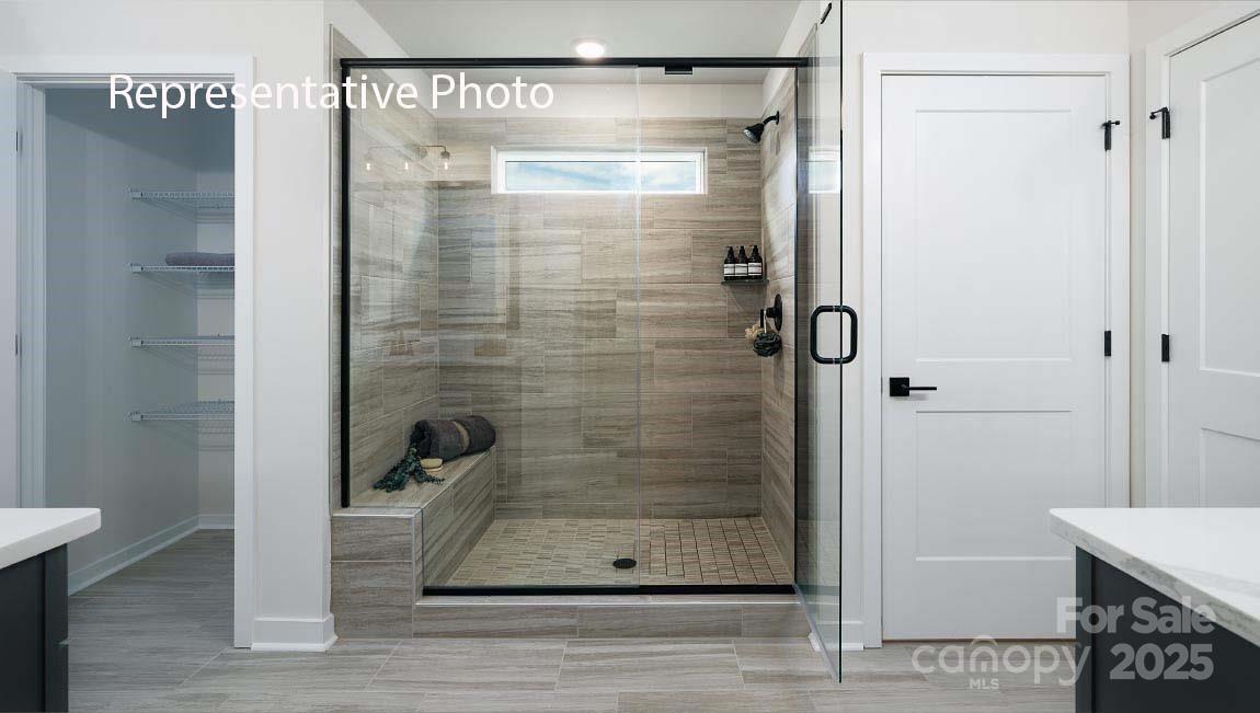 3044 Canvasback Way Indian Trail, NC 28079 - Photo 30 of 43 a bathroom with a glass shower door