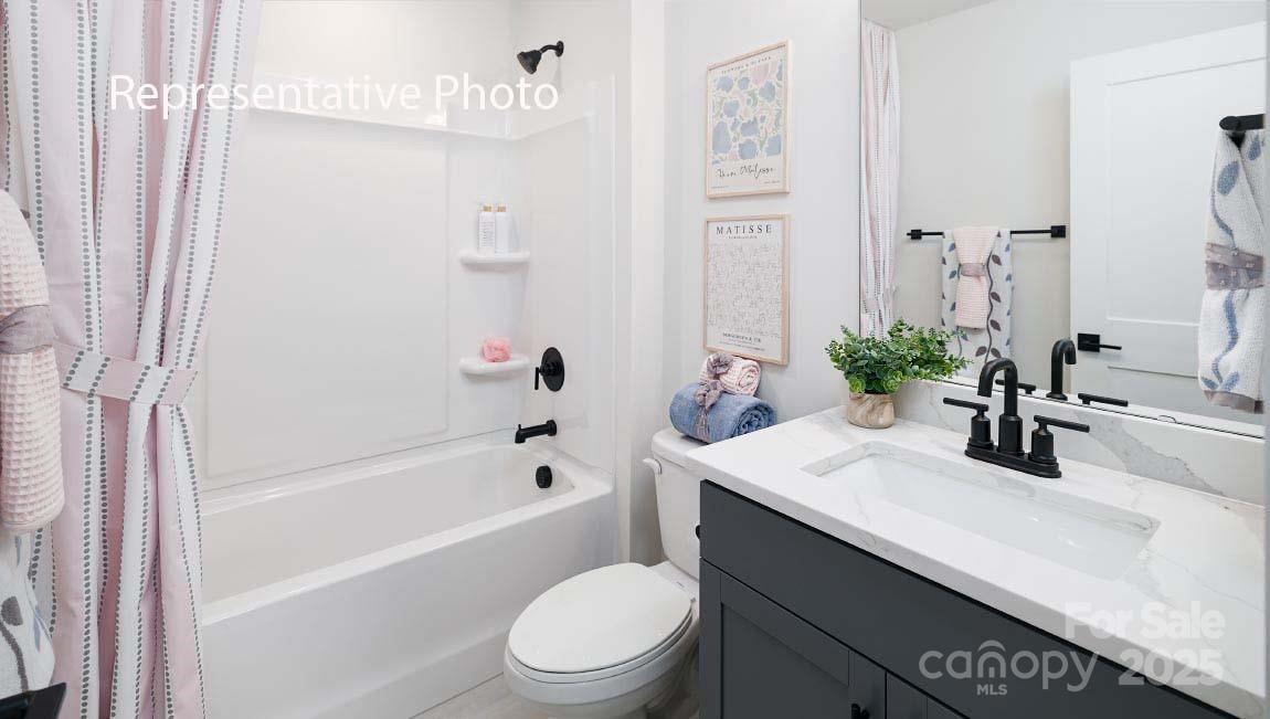 3044 Canvasback Way Indian Trail, NC 28079 - Photo 37 of 43 a bathroom with a sink a toilet a mirror and shower