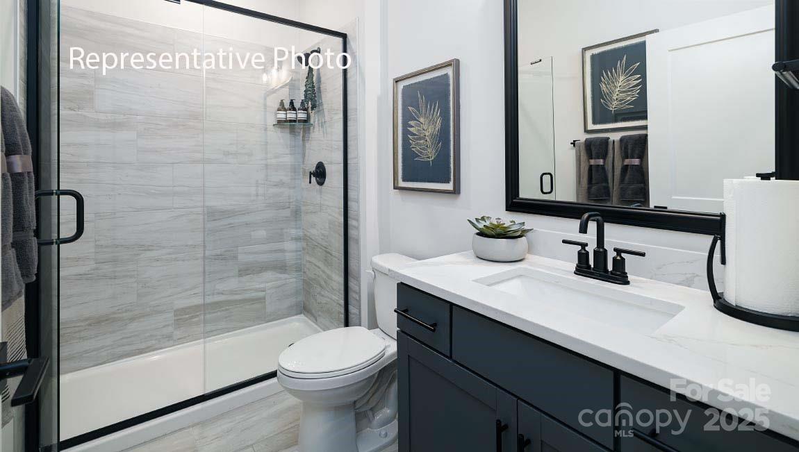 3044 Canvasback Way Indian Trail, NC 28079 - Photo 38 of 43 a bathroom with a sink a toilet and shower