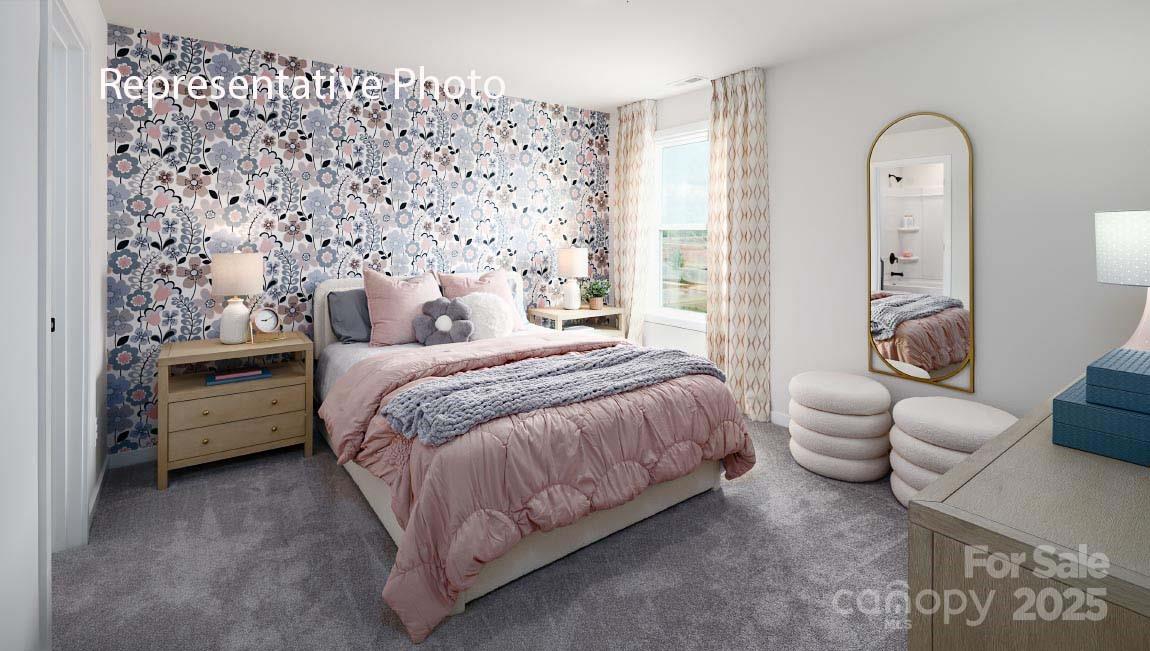 3044 Canvasback Way Indian Trail, NC 28079 - Photo 39 of 43 a spacious bedroom with a bed and a couch