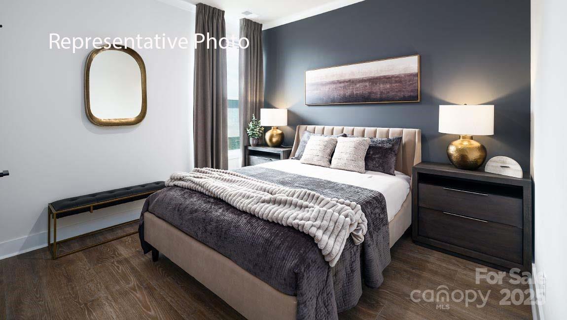 3044 Canvasback Way Indian Trail, NC 28079 - Photo 41 of 43 a bedroom with a bed and a chandelier