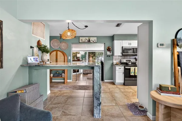 a kitchen with stainless steel appliances kitchen island granite countertop a refrigerator and stove
