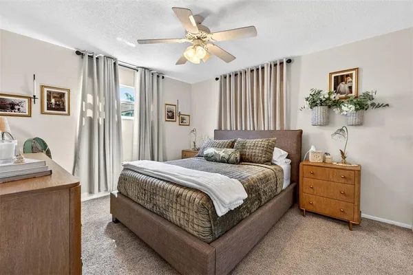 a bedroom with a large bed and a flat screen tv