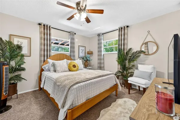 a bedroom with a bed and a flat tv screen