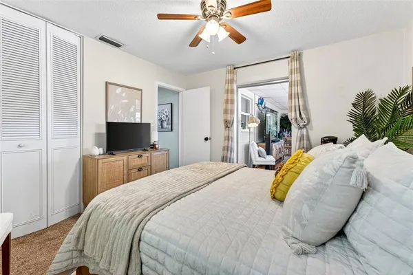 a bedroom with bed and flat screen tv