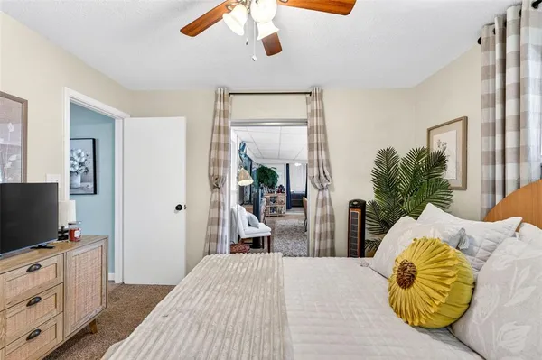 a bedroom with a large bed and a chandelier