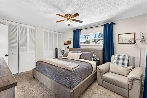 a bedroom with a bed and a painting on the wall