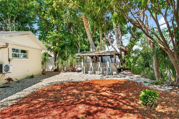 a front view of a house with a yard and shrubs