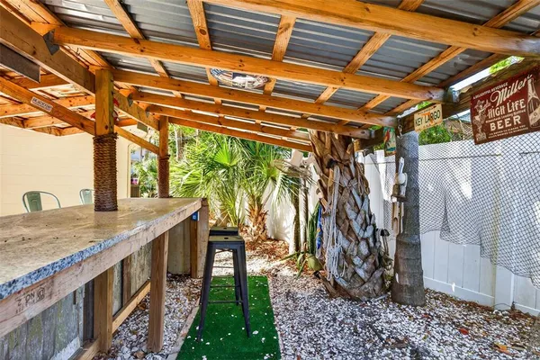 a view of a chairs with table in a backyard