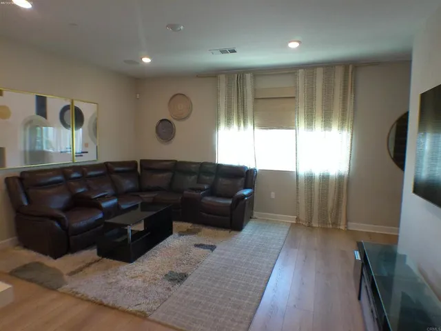 a view of a dining room with furniture and a chandelier