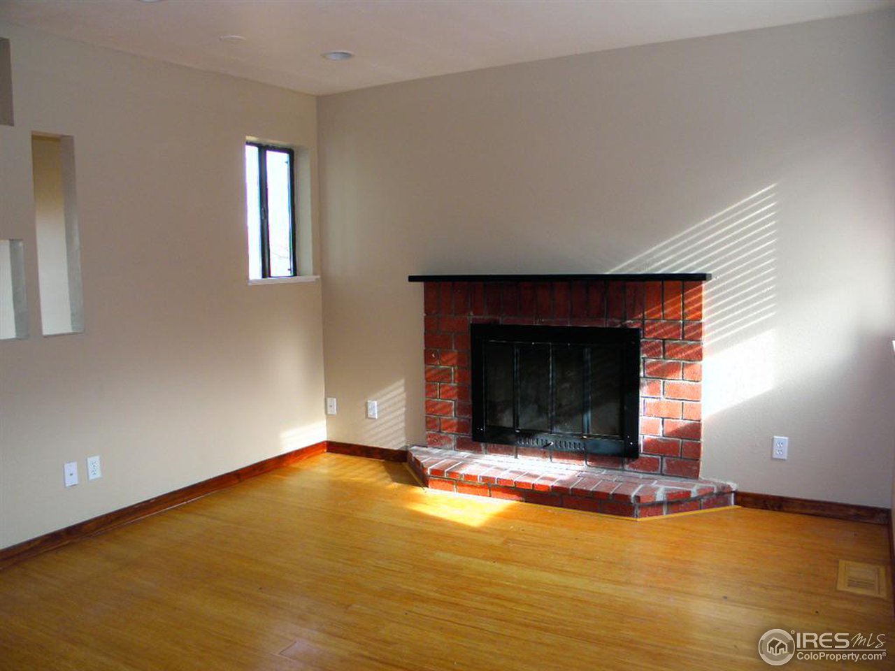 6628 Kalua Road Boulder, CO 80301 - Photo 2 of 13 a view of an empty room with window and fireplace