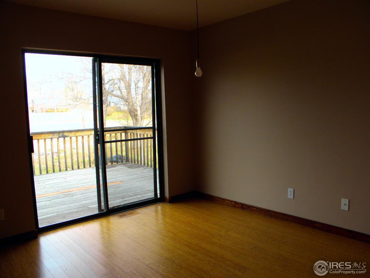 6628 Kalua Road Boulder, CO 80301 - Photo 3 of 13 a view of an empty room with wooden floor and a window