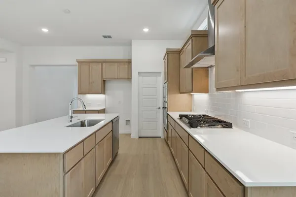a kitchen that has a sink and a stove
