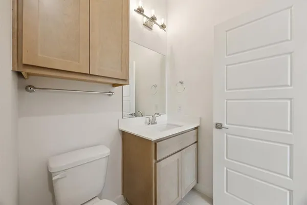 a bathroom with a sink a toilet and vanity