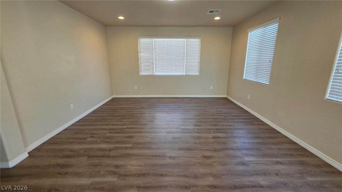 6977 Florido Road Las Vegas, NV 89178 - Photo 13 of 22 A versatile living space awaits, featuring recessed lighting and durable wood-look flooring.