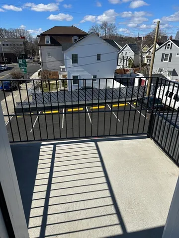 a view of a balcony with two chairs and wooden fence