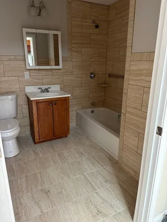 a bathroom with a sink a toilet and bathtub