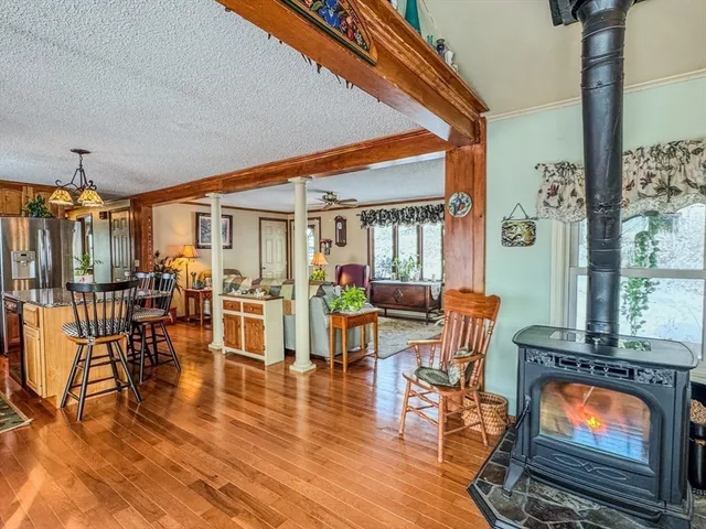 a living room with furniture wooden floor and a fireplace