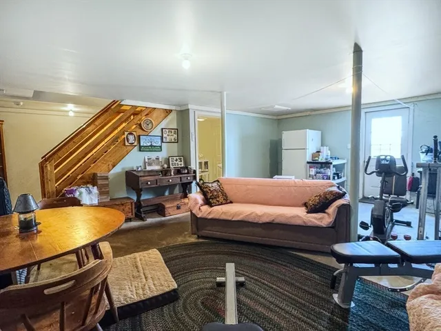 a bedroom with a bed a bookshelf and a chair