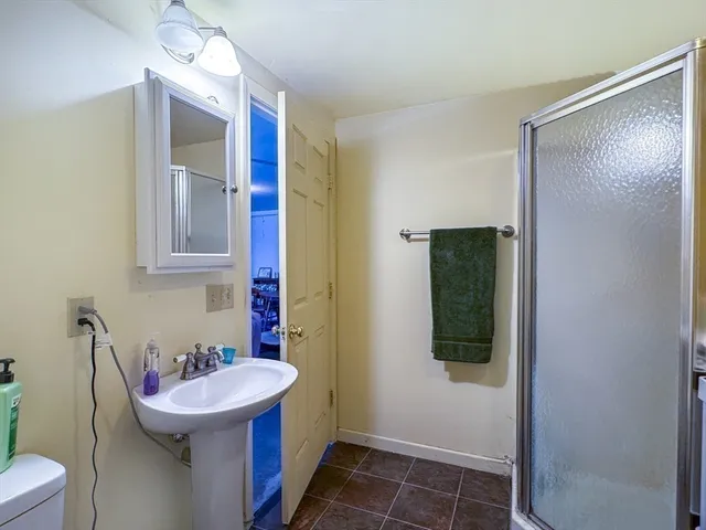 a bathroom with a sink and mirror with toilet