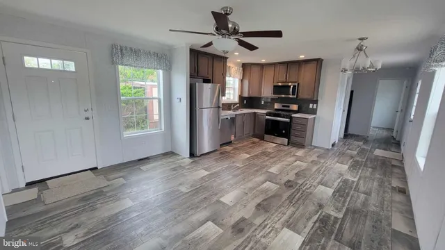 a view of a kitchen with a sink a refrigerator and a window