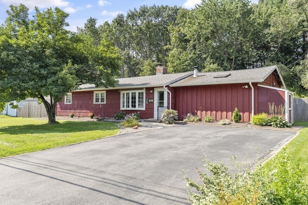 a front view of a house with a yard and a garage